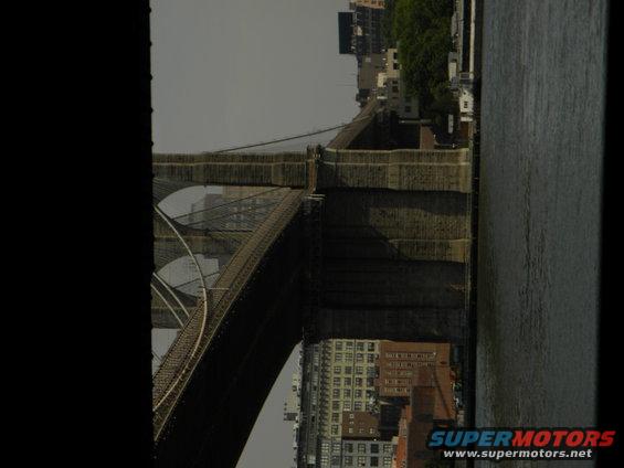 Brooklyn Bridge with New York City buildings and water visible