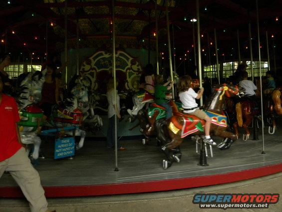 Carousel horses with children riding