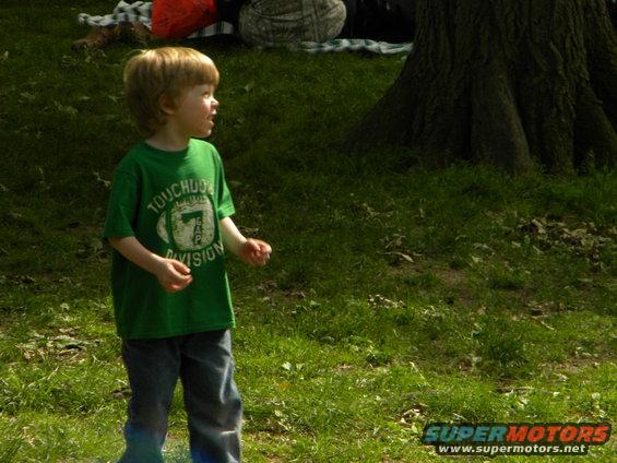 Child in green t-shirt with football graphic