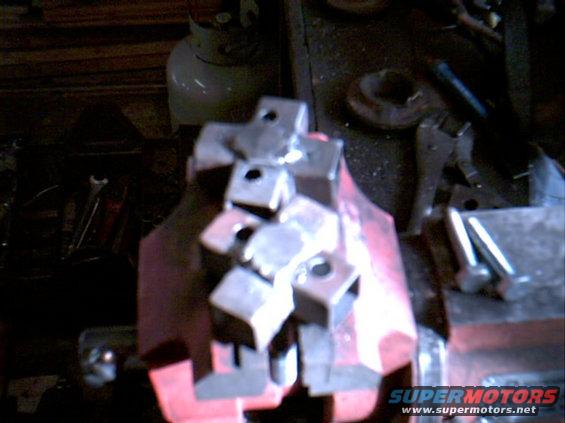 adaptorwholes1.jpg Here is the bottom with the spaced holes to match the 79 arm and the big bolt for the 80 coil with the head of the bolt ground down and welded on.