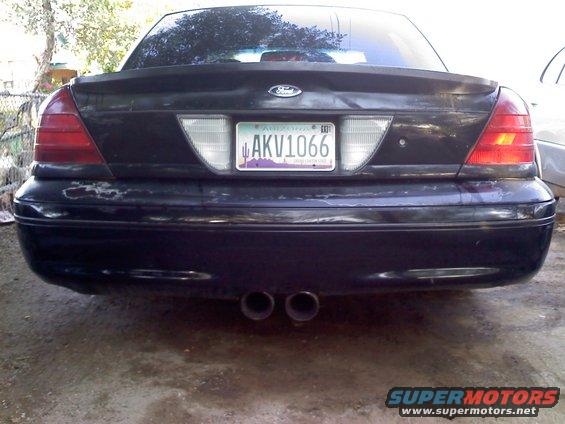 Rear view of a black Ford Crown Victoria with dual exhaust pipes and an Arizona license plate