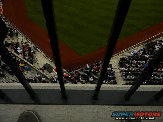 View from above looking down at a baseball field and stadium seating with spectators