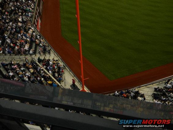 Baseball stadium with green field and dirt base paths, viewed from above