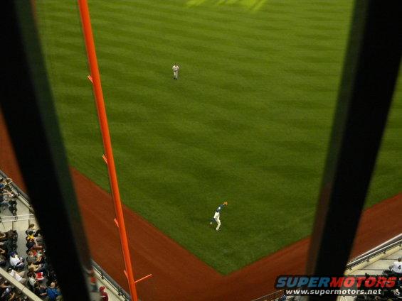 baseball player catching a ball on a field, seen from above