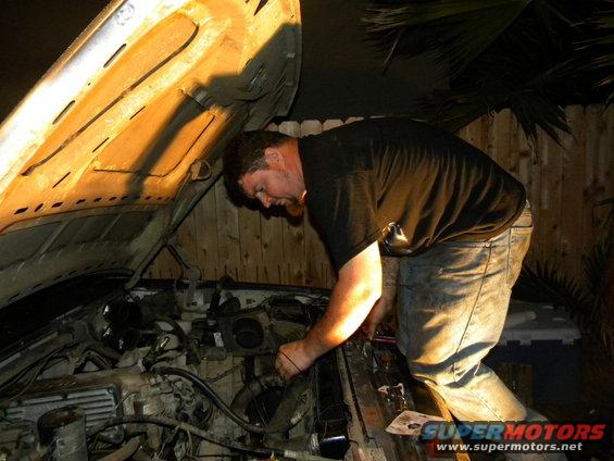 1992 Ford Bronco engine bay with man working on it
