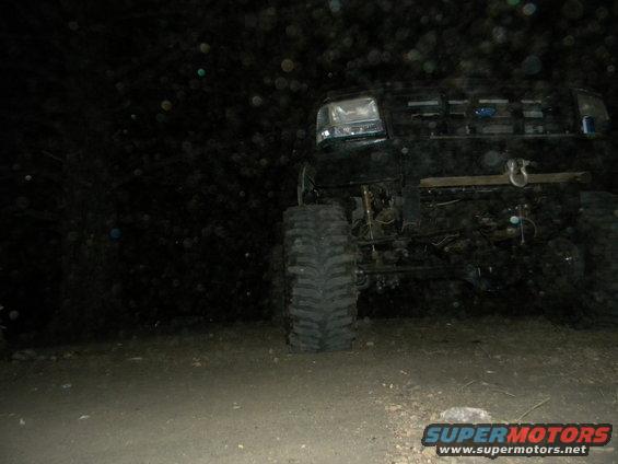 1992 Ford Bronco front quarter view at night, showing large tires and winch
