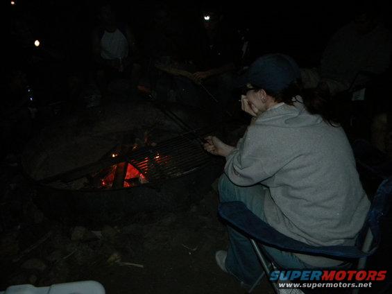 People sitting around a campfire at night