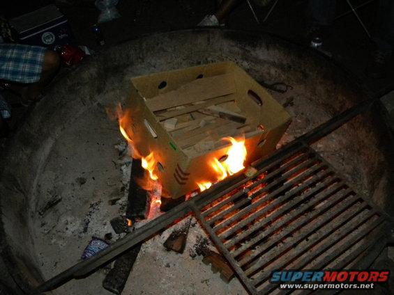 Fire burning in a dark space with some objects around it