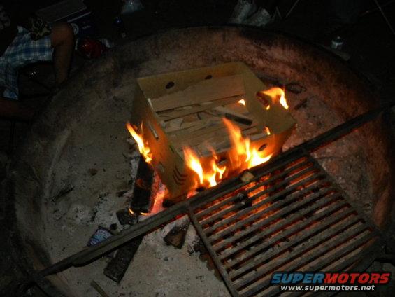 Fire burning on a metal grate at night