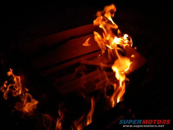 Fire engulfs a dark area, with bright orange and yellow flames