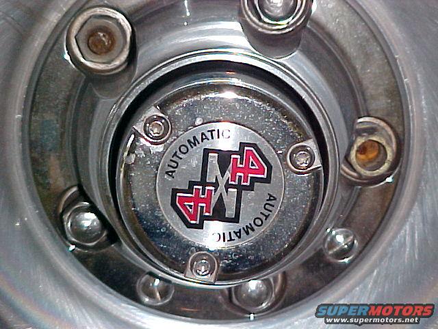 Close-up of an automatic locking hub with a red and black 4x4 emblem and 'AUTOMATIC' text