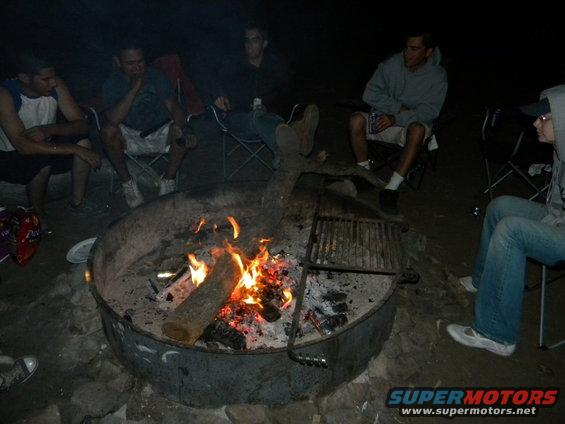 People gathered around a bonfire at night
