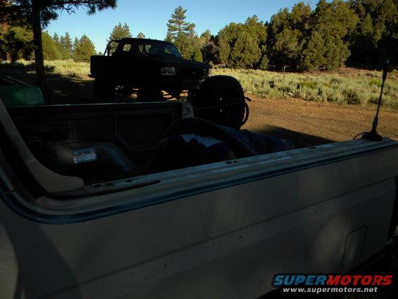 Black pickup truck with roll bar parked outdoors