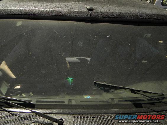 Dusty vehicle interior with dashboard and windshield wipers