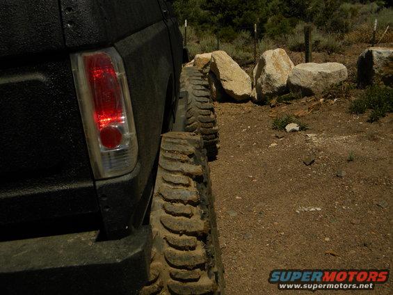 Black 1992 Ford Bronco rear quarter panel with large off-road tires