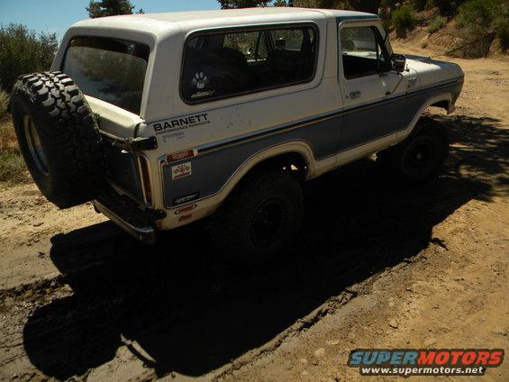 1978 Ford Bronco with spare tire on rear, parked on dirt road