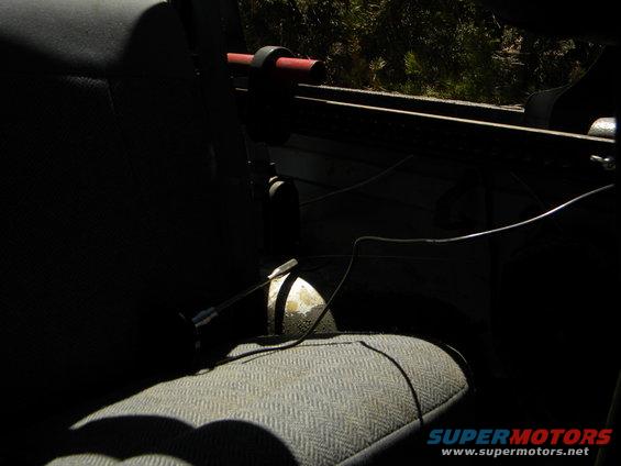Interior shot of a vehicle showing a seat and part of the roll bar