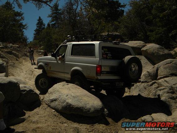 White 1992 Ford Bronco navigating a rocky trail