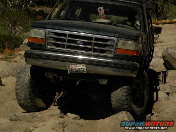 Dark green 1992 Ford Bronco on rocky terrain, front view