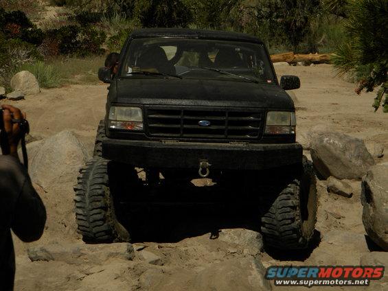 Black 1992 Ford Bronco navigating rocky terrain