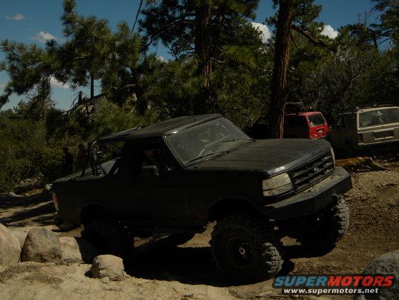 1992 Ford Bronco on rocky trail with other SUVs in background