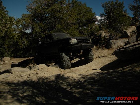 Black 1992 Ford Bronco on rocky terrain, front-left view