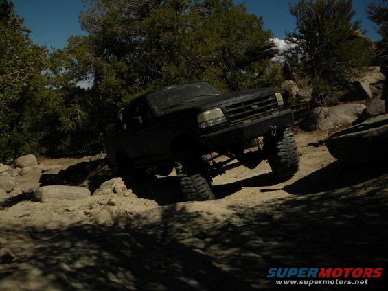 Black 1992 Ford Bronco climbing a rocky incline