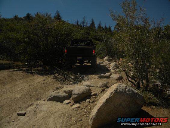 1992 Ford Bronco driving on a rocky trail