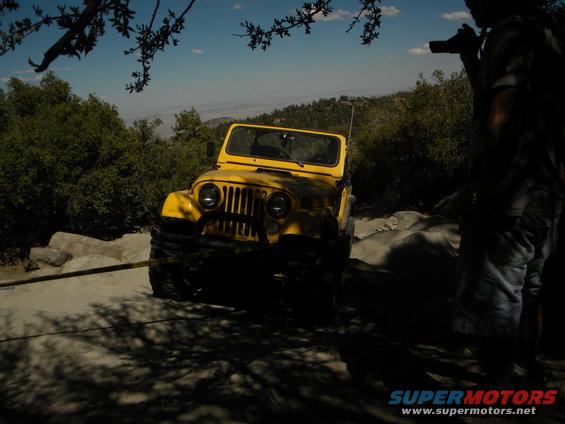 Yellow jeep on rocky terrain