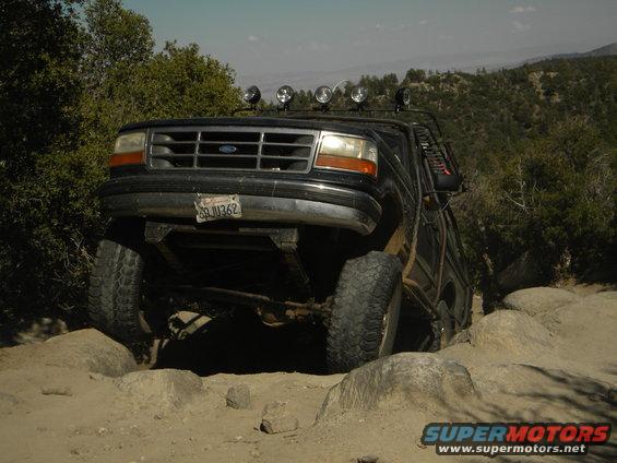 Black 1992 Ford Bronco on rocky terrain, front view