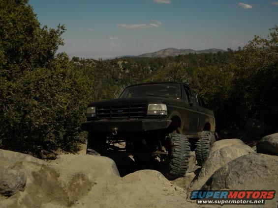 Black 1992 Ford Bronco on rocky trail