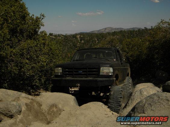 Black 1992 Ford Bronco navigating rocks on a trail