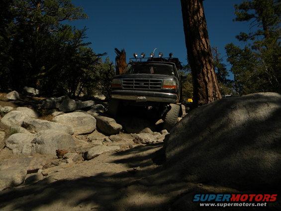 Black 1992 Ford Bronco navigating a rocky off-road trail