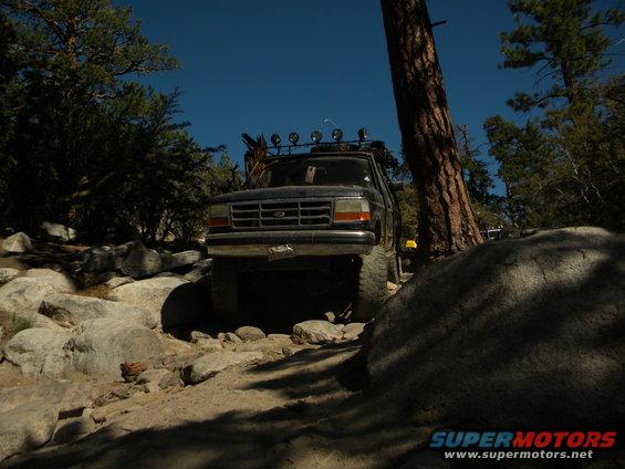 1992 Ford Bronco front view on rocky trail with roof lights