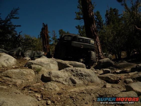 Black 1992 Ford Bronco navigating a boulder field