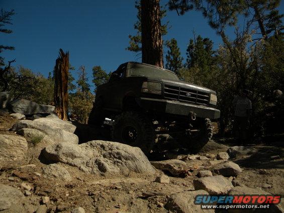 Dark green 1992 Ford Bronco navigating a rocky off-road trail