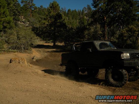 Black 1992 Ford Bronco 3q-front view on dirt road