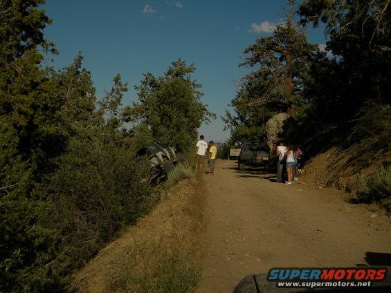 Off-road vehicle tipped on its side on a dirt road