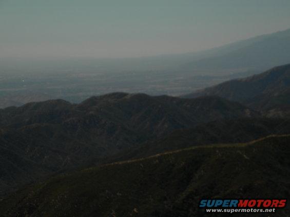 Misty mountain range with a distant valley and sky