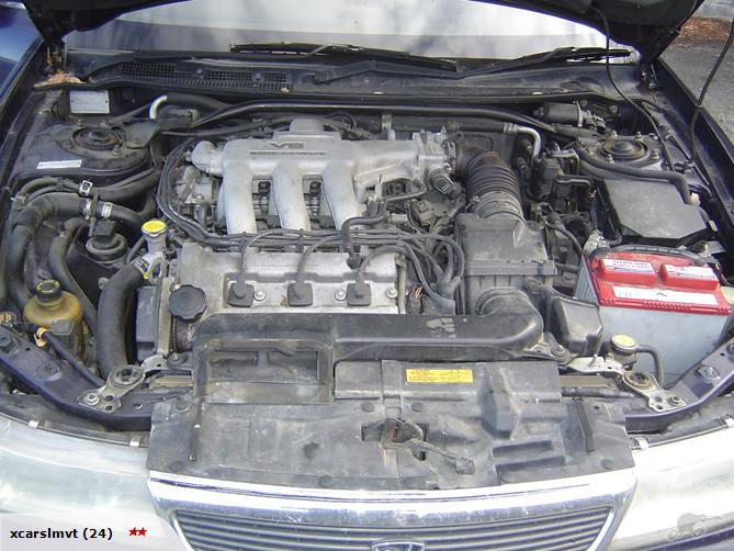 Engine bay with V6 engine and red battery