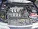 1993 Mazda MX-3 - The engine bay of a vehicle, a V6 engine and a red car battery.