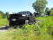 2001 Ford Excursion - This modified Ford Excursion is shown off-road with a custom front bumper and large tires.