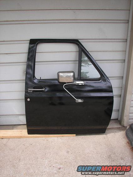 Black truck door with chrome side mirror and handle