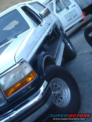 1993 Ford Bronco front quarter view, parked next to a white truck