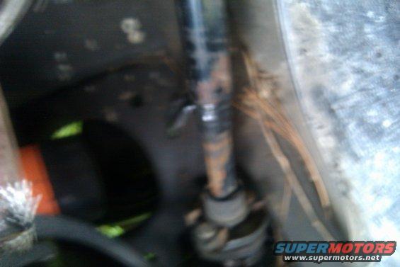 Close-up of a rusty steering shaft and U-joint assembly