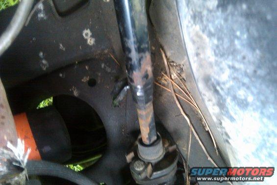 Close-up of a rusty steering column and part of the vehicle frame