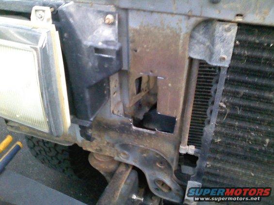 1990 Ford Bronco front end with rusted metal and a headlight