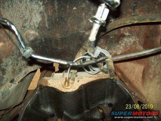 Close-up of wiring and metal parts in a vehicle's engine bay