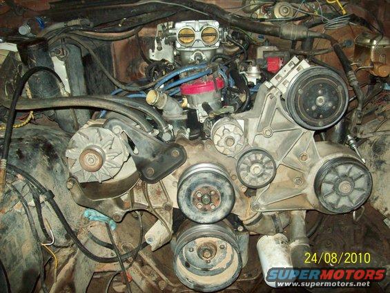 Engine bay with V8 engine, carburetor, and accessory belts