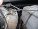 1995 Ford F-150 - The engine compartment shows various parts and wiring, with a prominent silver insulated pipe and a grey engine cover.